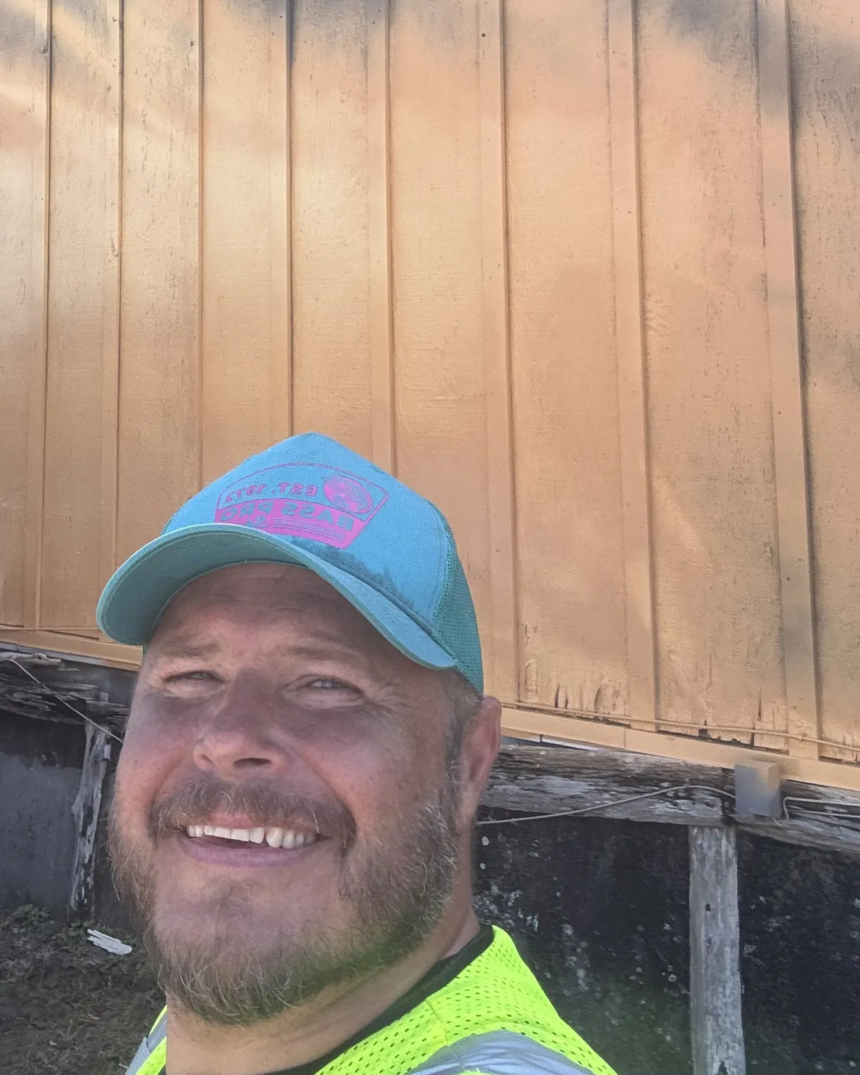 David Neeld smiling on the lift in front of the Parkers Mercantile wall