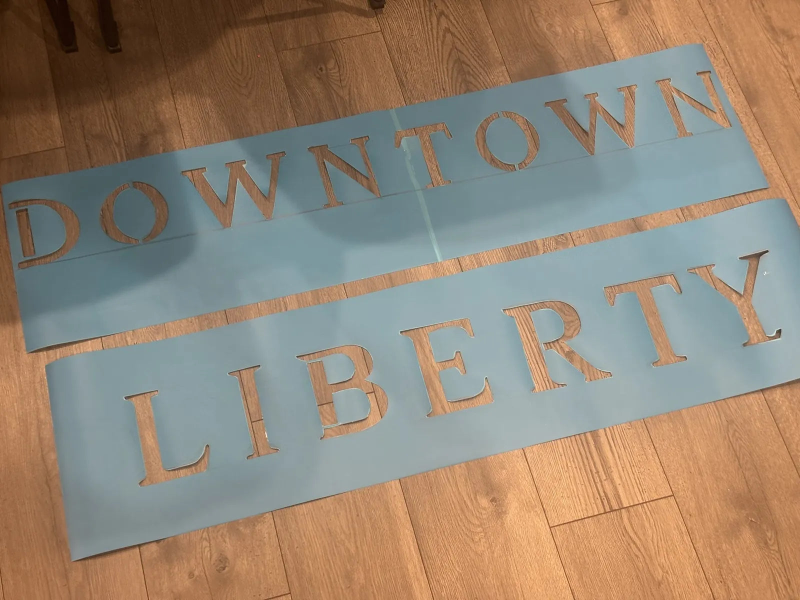 Hand-cut DOWNTOWN LIBERTY lettering stencils