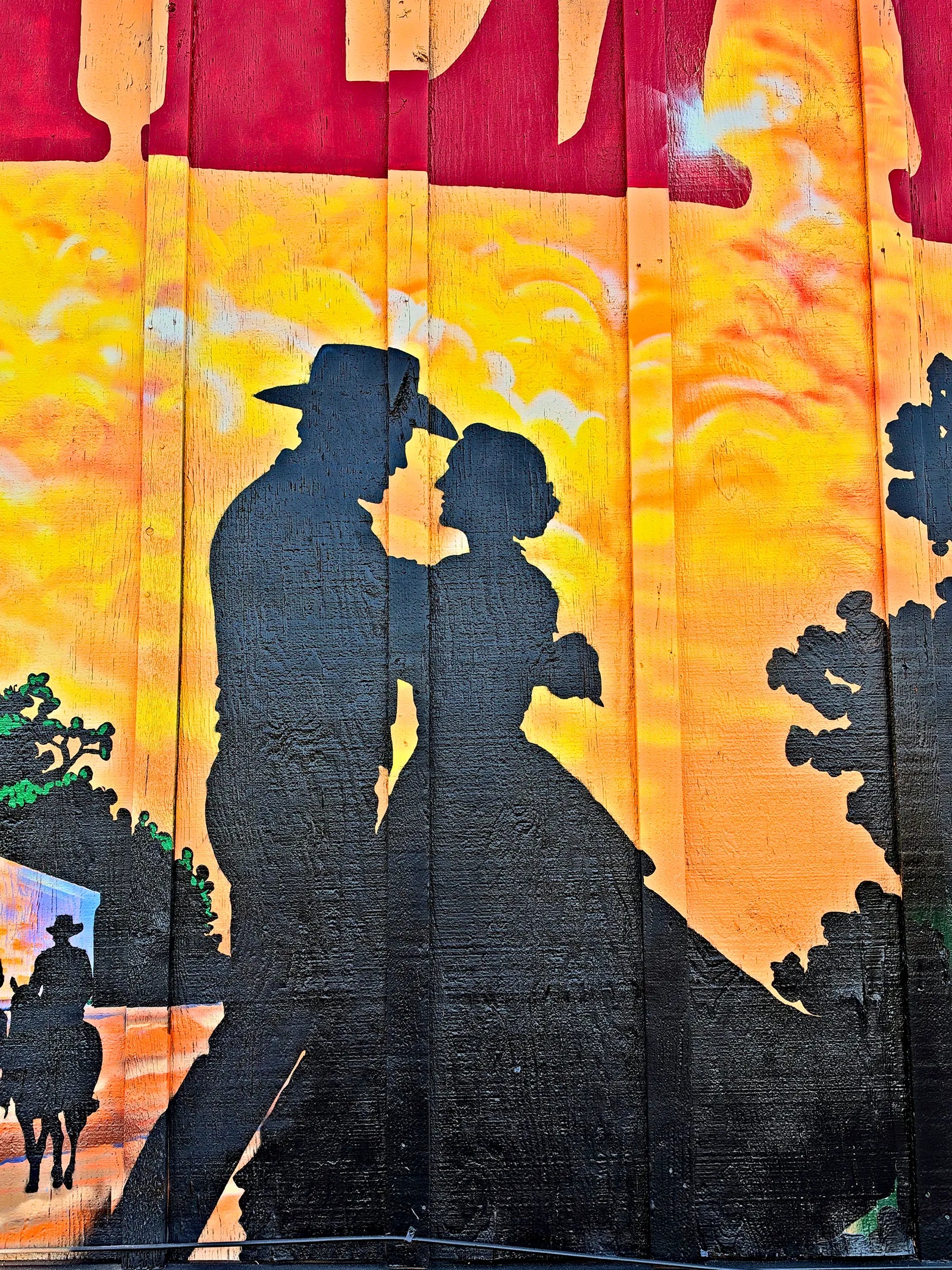 Silhouette of a cowboy and his sweetheart against a golden Hill Country sunset