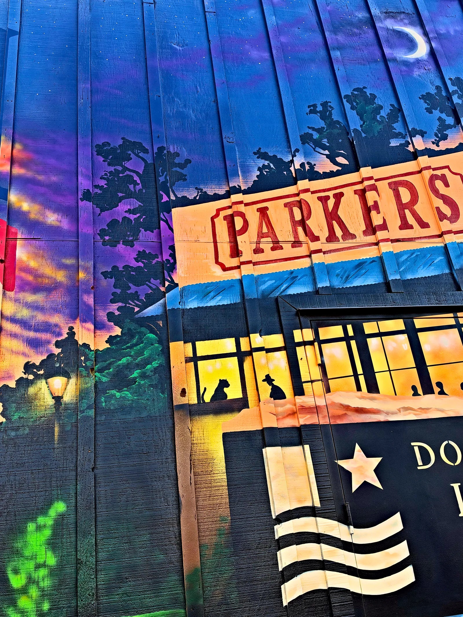 Crescent moon and twilight sky above the painted PARKERS building