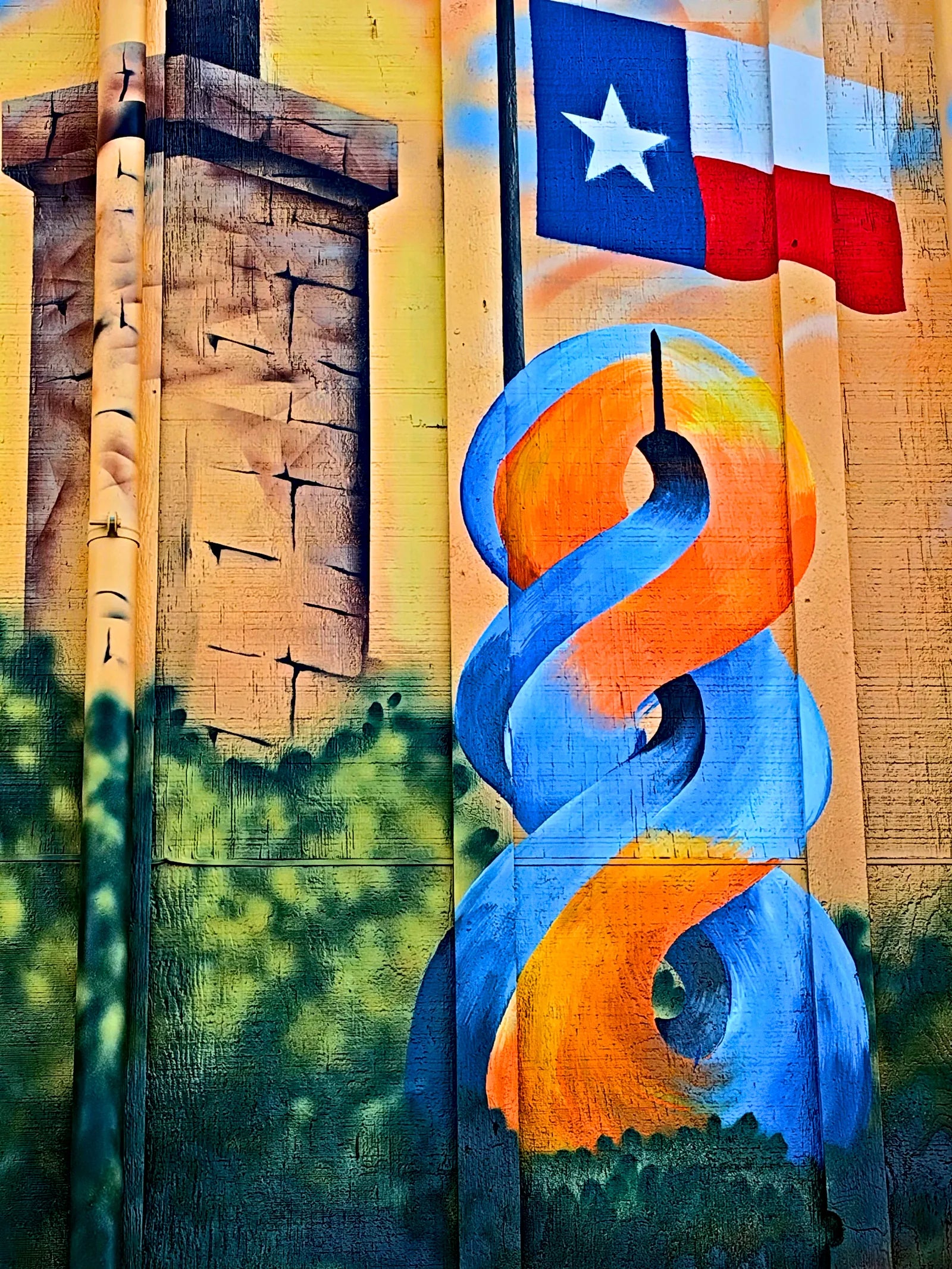 Stone tower, Texas flag and the orange and blue 8 ribbon on the finished mural