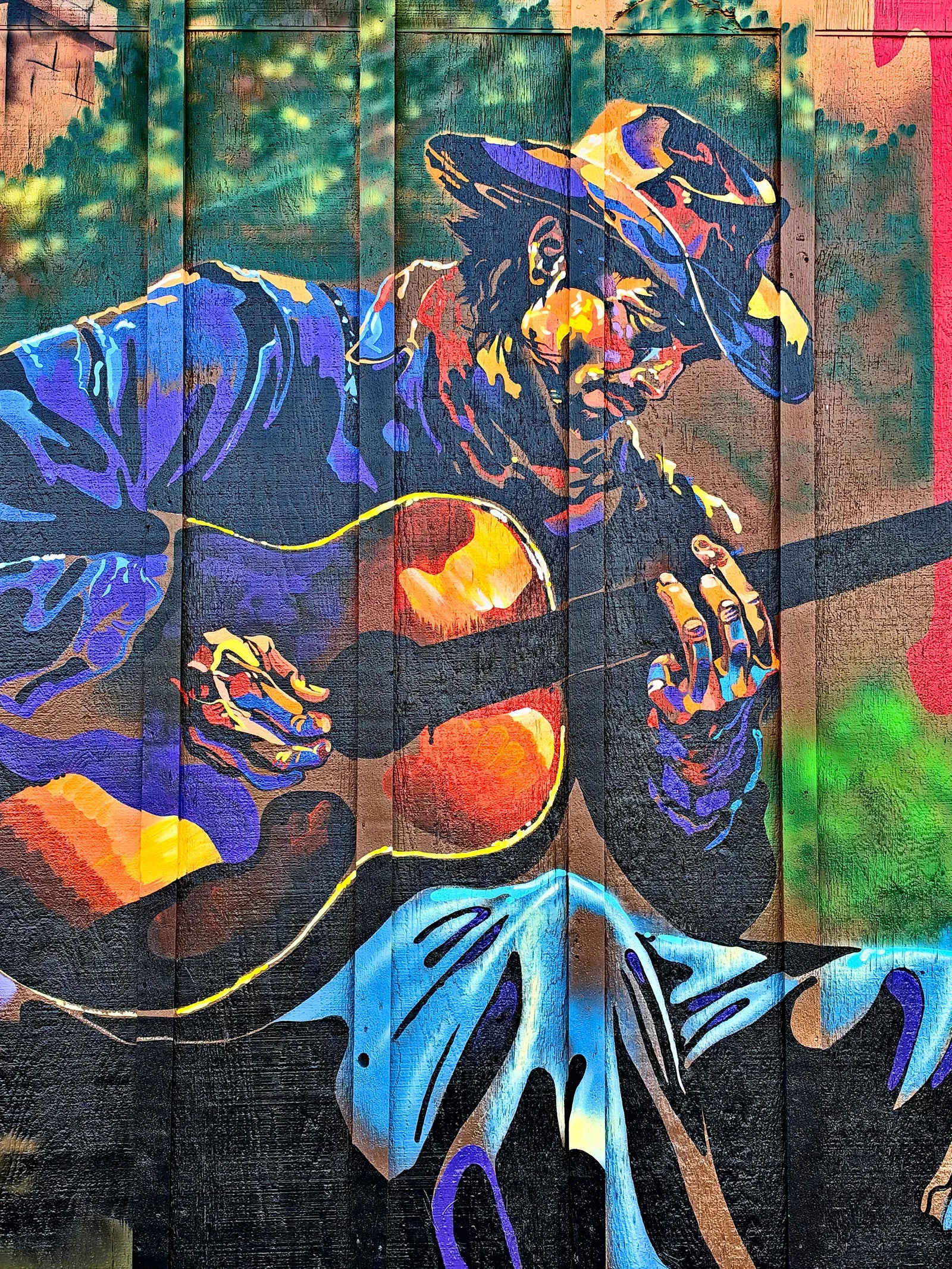 Painted guitar player in a cowboy hat on the Parkers mural